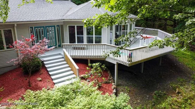 a view of balcony with wooden floor and seating space
