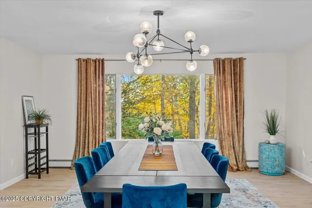 an aerial view of residential house with outdoor space and trees all around