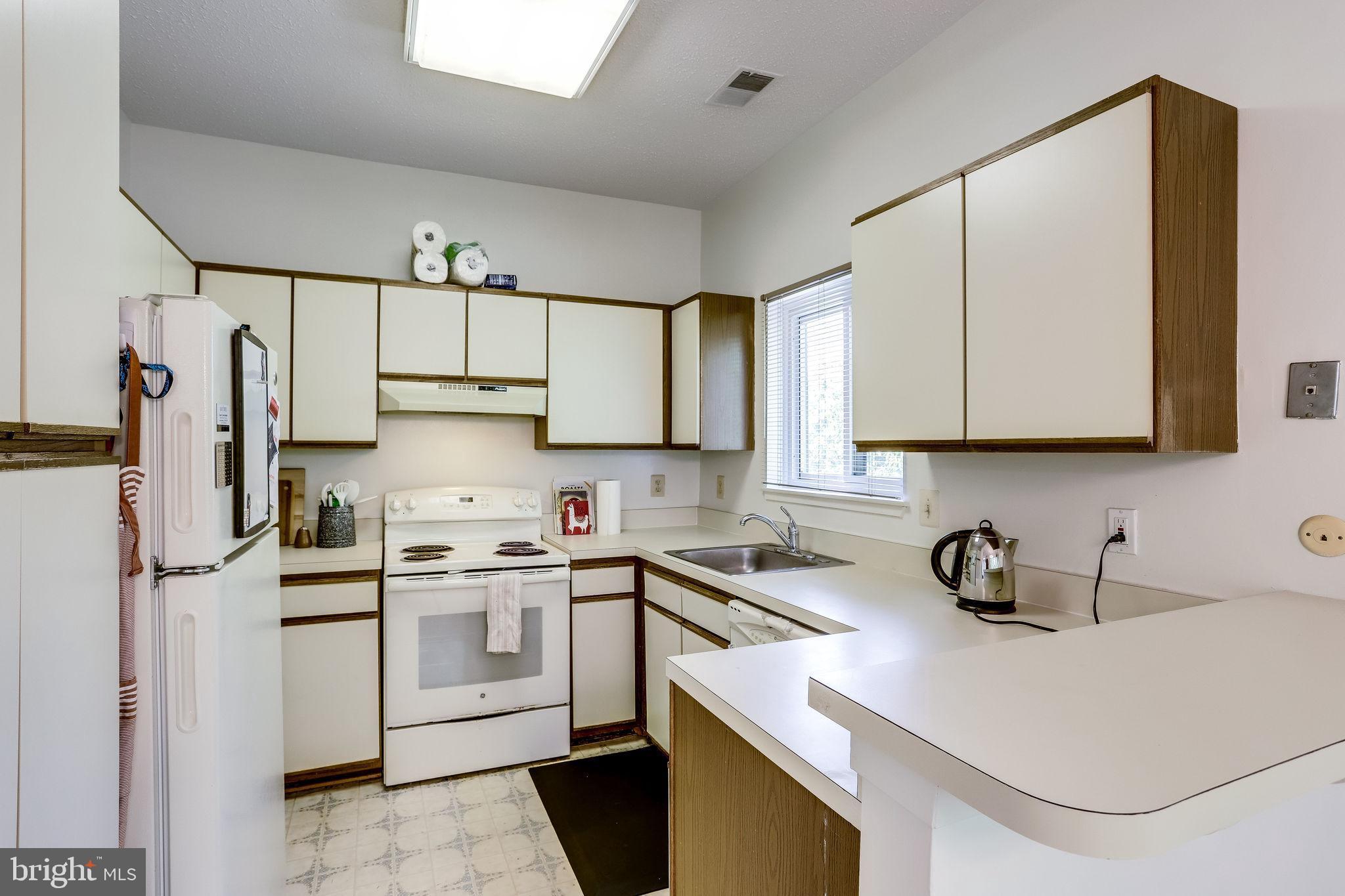 11027 Villaridge Court Reston, VA 20191 - Photo 15 of 28 a kitchen with stainless steel appliances granite countertop a sink a stove a refrigerator and cabinets