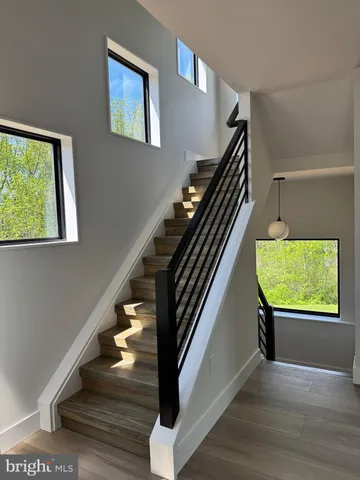 a view of staircase with wooden floor and windows