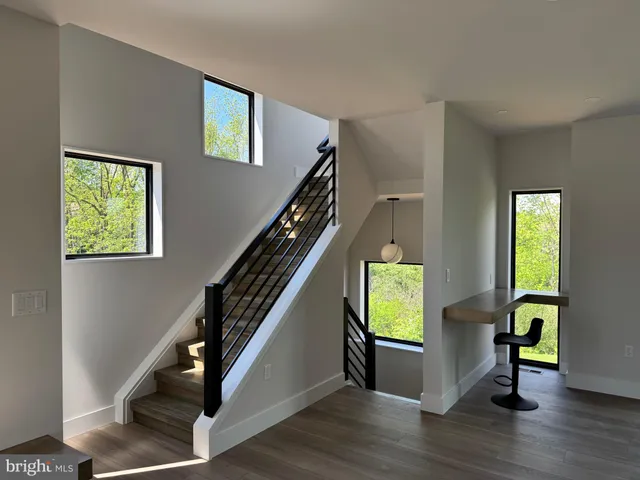 a view of an entryway with wooden floor windows and a livingroom