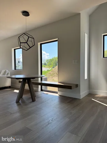 a room with gym equipment and wooden floor
