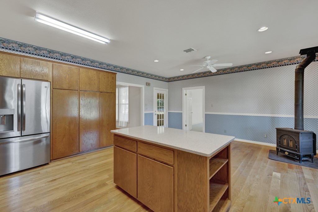 82 Bell Mountain Road Willow City, TX 78675 - Photo 16 of 41 a kitchen with a refrigerator and a sink