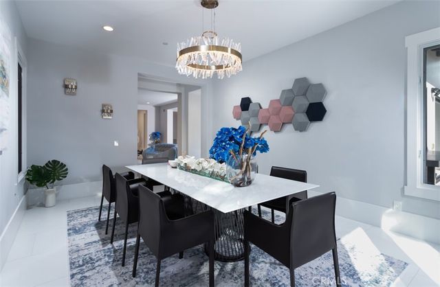 a view of a dining room with furniture and chandelier