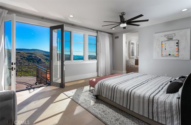 a bedroom with a large bed and a large window