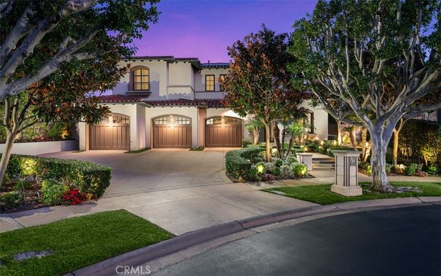 a front view of a house with a yard and a garden