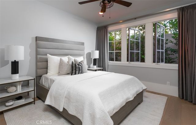 a bedroom with a large bed and a large window