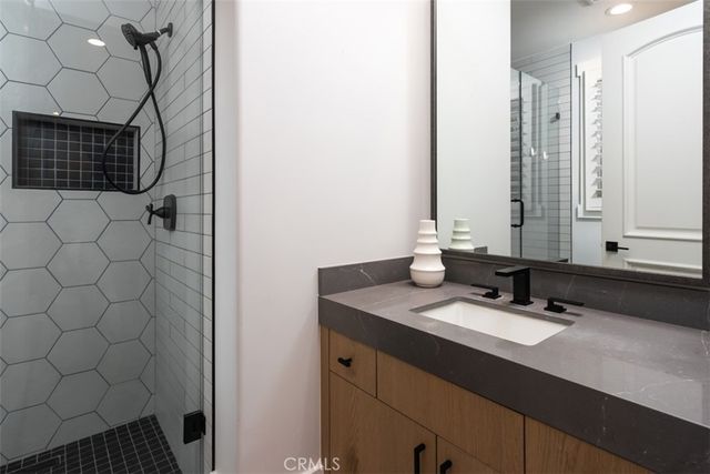 a bathroom with a sink vanity and a mirror