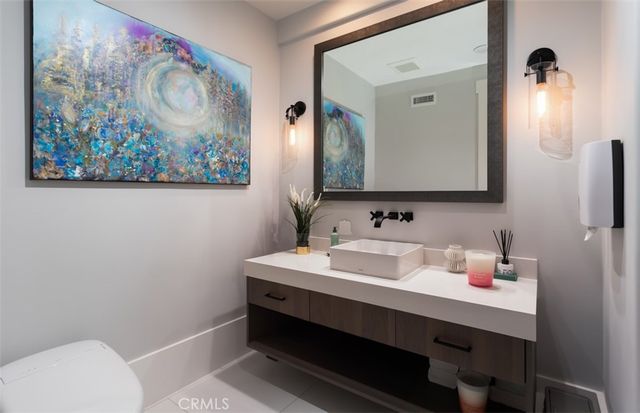 a bathroom with a sink vanity and a mirror