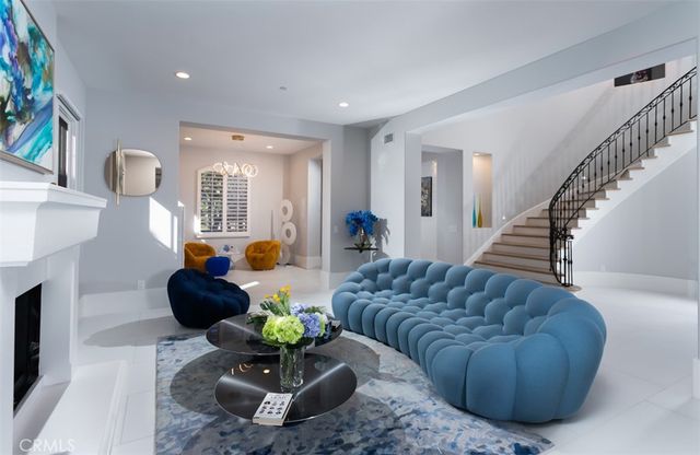 a living room with furniture potted plant and a fireplace