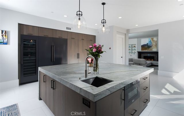 a kitchen with stainless steel appliances granite countertop a sink dishwasher and a refrigerator