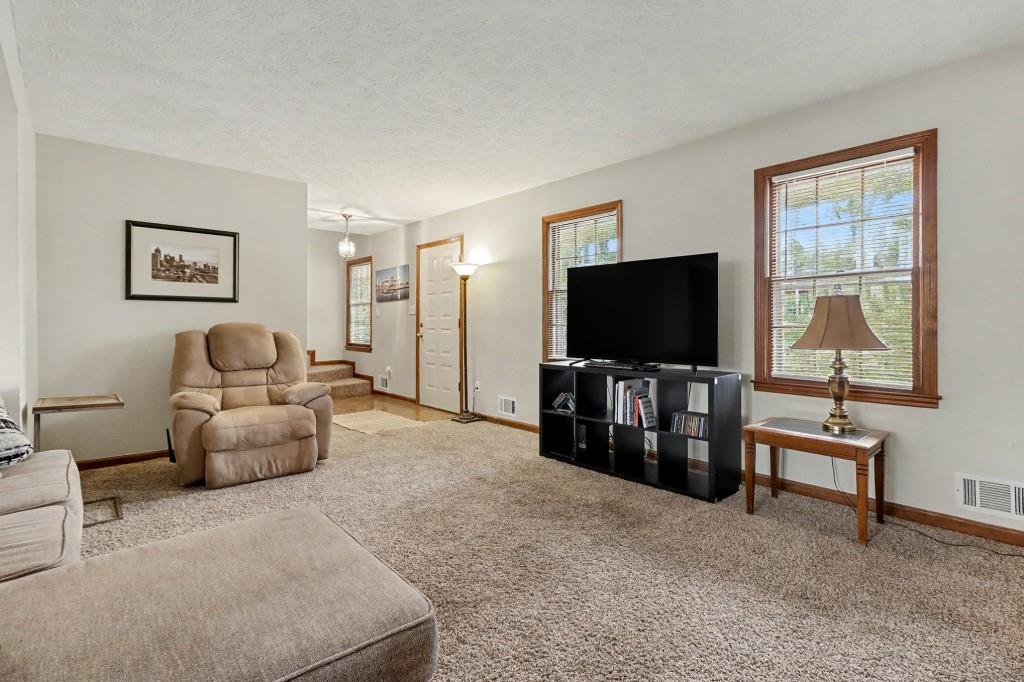 9133 Snipe Lane Jonesboro, GA 30236 - Photo 11 of 36 a living room with furniture and a flat screen tv