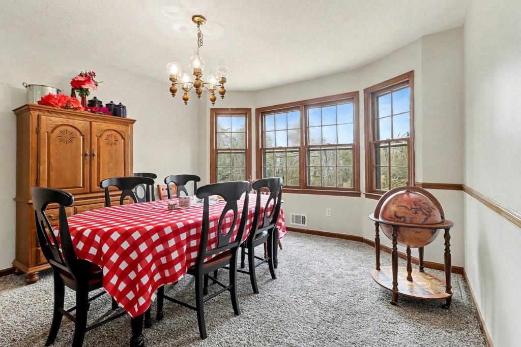 9133 Snipe Lane Jonesboro, GA 30236 - Photo 13 of 36 a dining room with furniture a chandelier and window