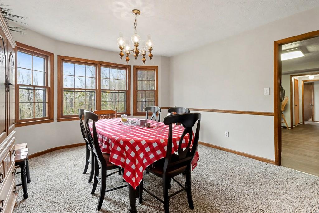 9133 Snipe Lane Jonesboro, GA 30236 - Photo 14 of 36 a view of a dining room with furniture window and wooden floor