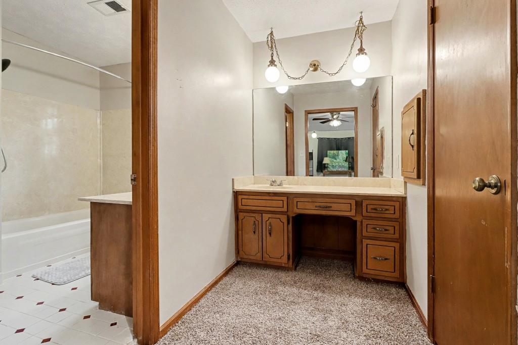 9133 Snipe Lane Jonesboro, GA 30236 - Photo 23 of 36 a bathroom with a sink and a mirror