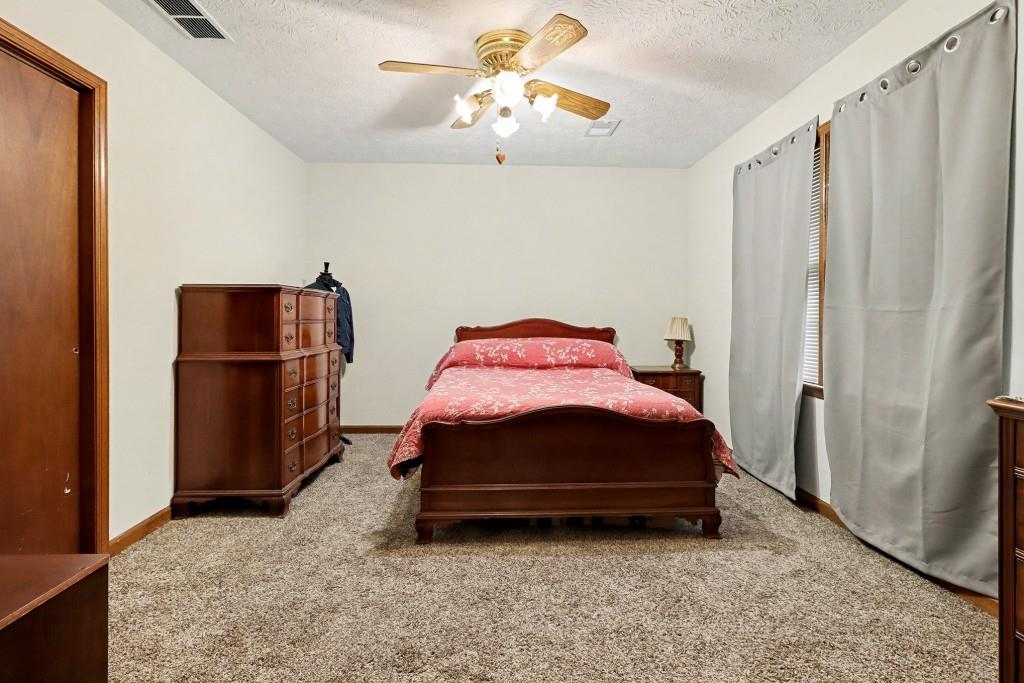 9133 Snipe Lane Jonesboro, GA 30236 - Photo 28 of 36 a bedroom with a bed and cabinets
