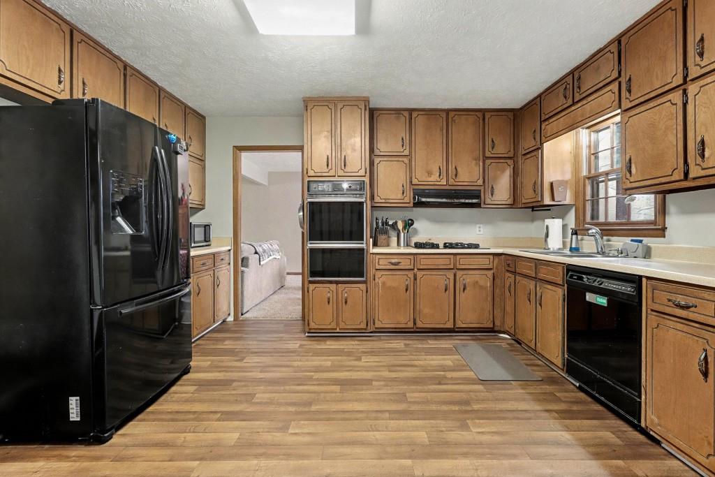 9133 Snipe Lane Jonesboro, GA 30236 - Photo 3 of 36 a kitchen with stainless steel appliances a refrigerator sink and cabinets