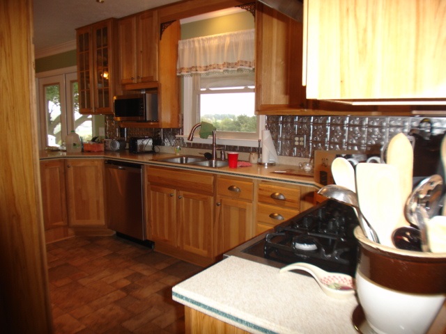 3777 Shutterlee Mill Road Staunton, VA 24401 - Photo 9 of 24 a kitchen with a sink and wooden cabinets