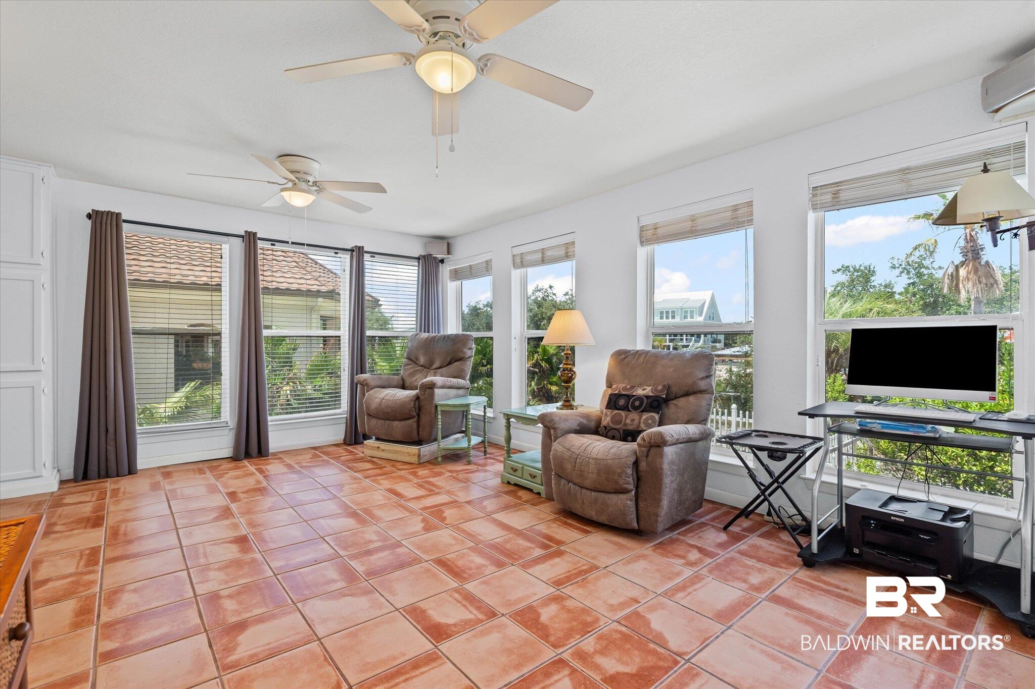 33129 River Road Orange Beach, AL 36561 - Photo 8 of 34 Sunroom featuring tile patterned flooring, plenty of natural light, and a wall mounted AC