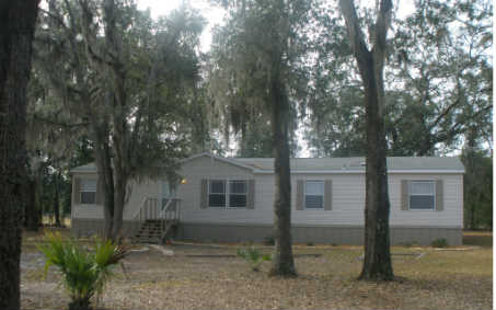 87073 Raddin Road Yulee, FL 32097 - Photo 1 of 20 a front view of a house with garden