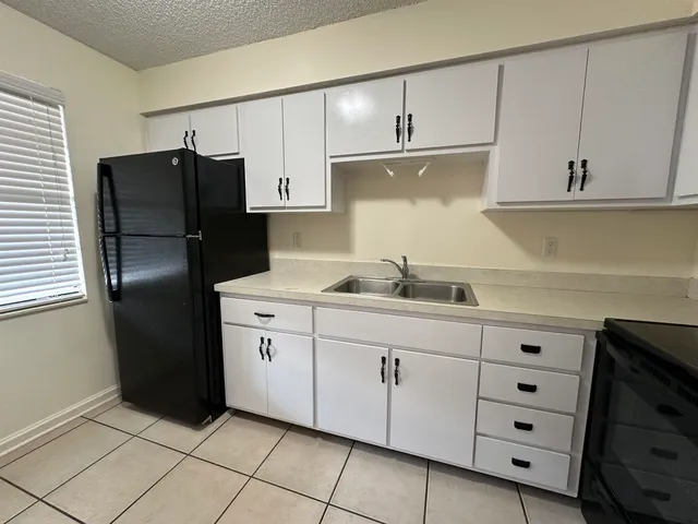 a kitchen with cabinets and stainless steel appliances
