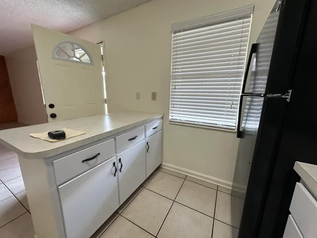 a utility room with cabinets washer and dryer