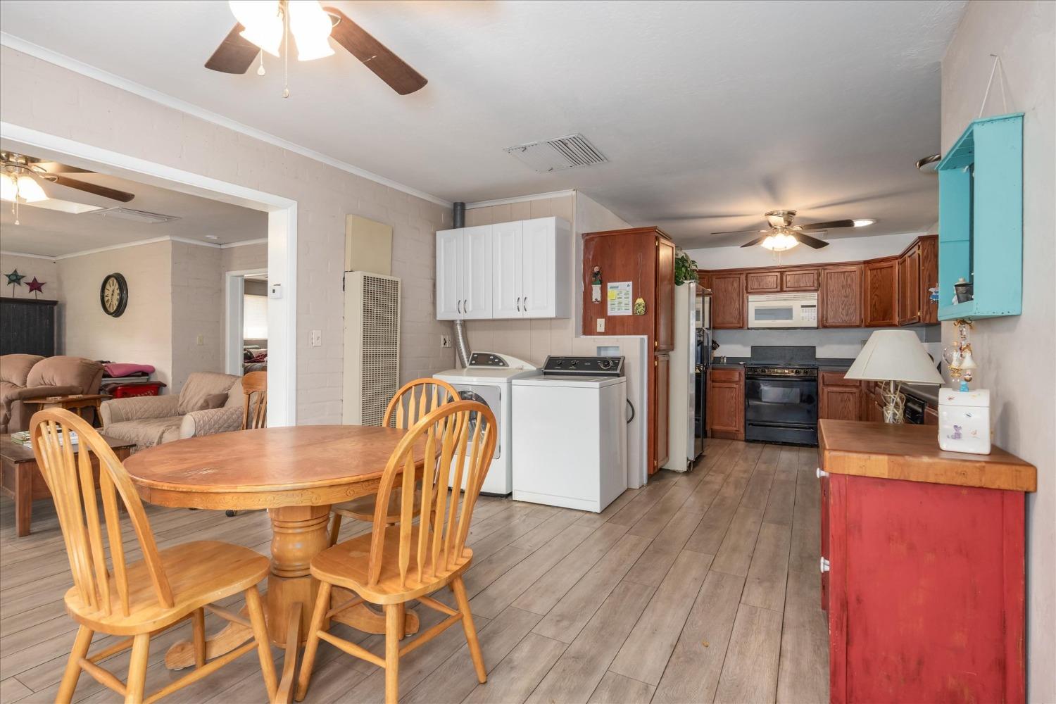 48994 Manzanita Road Oakhurst, CA 93644 - Photo 11 of 43 a kitchen with stainless steel appliances kitchen island granite countertop a table chairs and a refrigerator