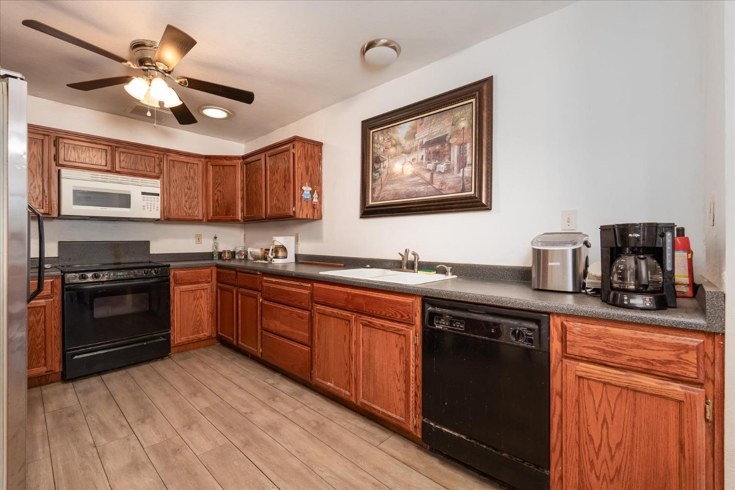 48994 Manzanita Road Oakhurst, CA 93644 - Photo 14 of 43 a kitchen with stainless steel appliances granite countertop a stove sink and cabinets
