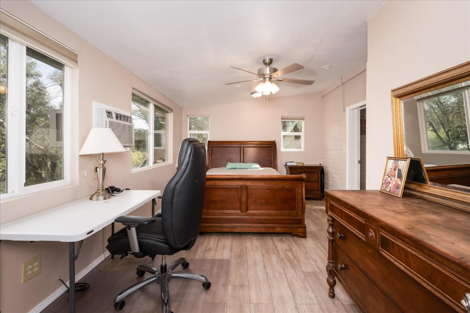 48994 Manzanita Road Oakhurst, CA 93644 - Photo 16 of 43 a view of a workspace with furniture and a window