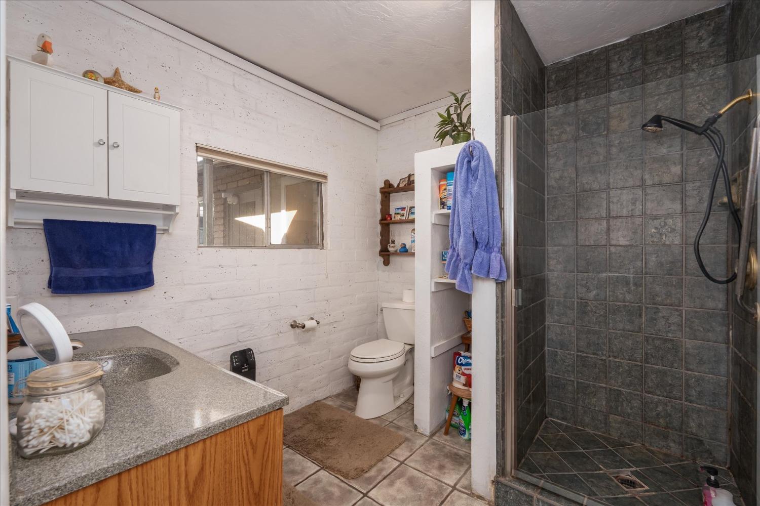 48994 Manzanita Road Oakhurst, CA 93644 - Photo 21 of 43 a bathroom with a sink toilet and shower