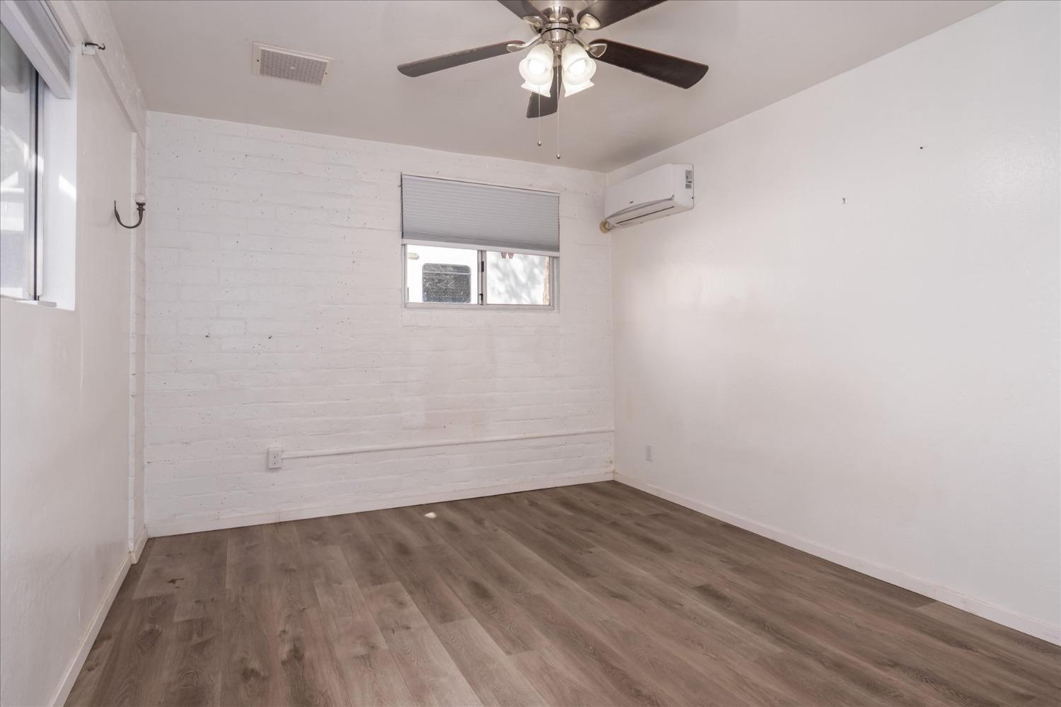 48994 Manzanita Road Oakhurst, CA 93644 - Photo 23 of 43 wooden floor in an empty room with a window