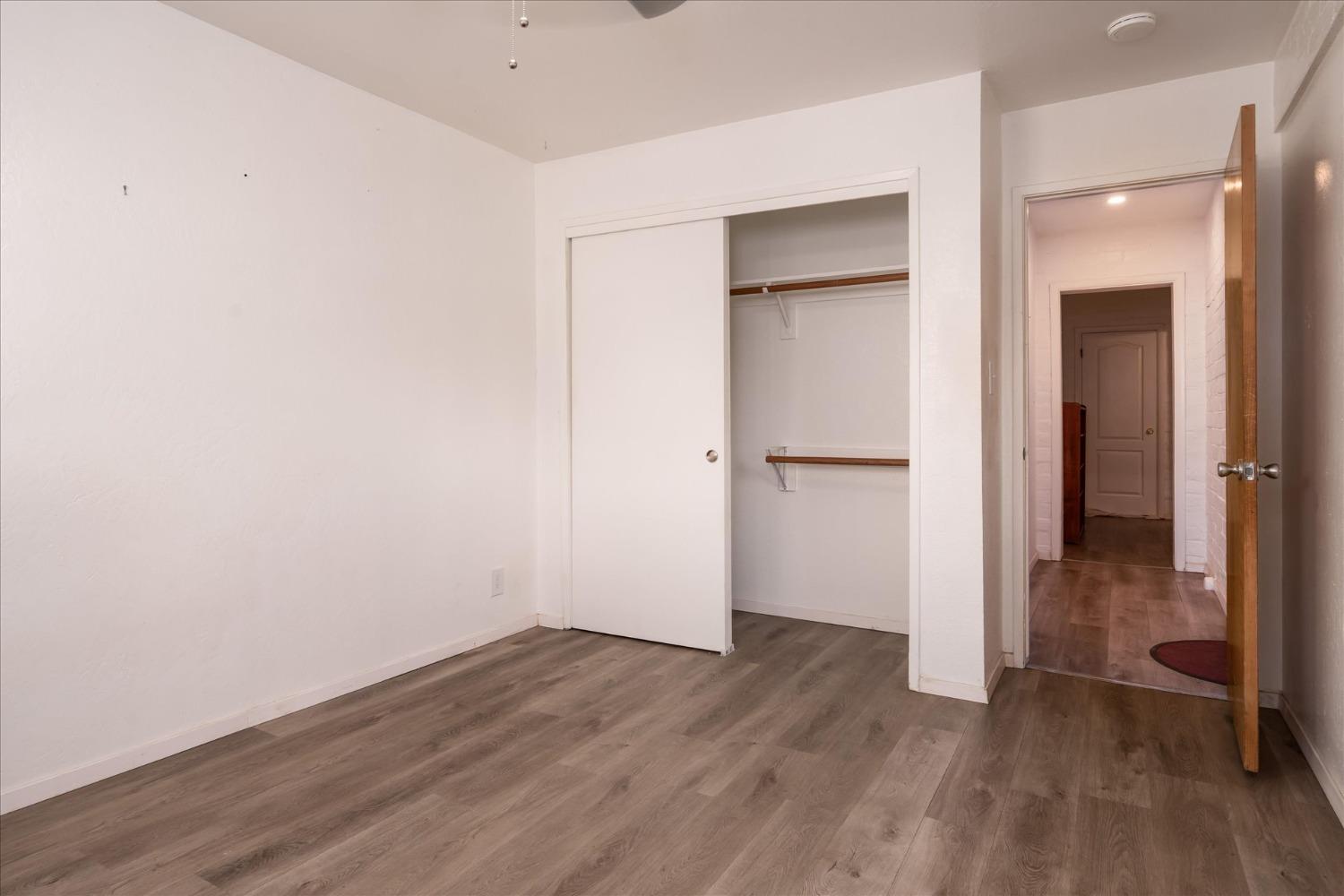 48994 Manzanita Road Oakhurst, CA 93644 - Photo 24 of 43 an empty room with wooden floor and entrance