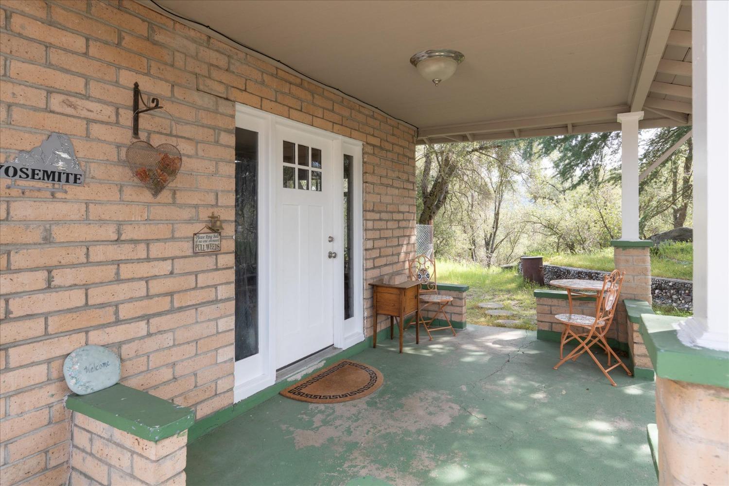 48994 Manzanita Road Oakhurst, CA 93644 - Photo 3 of 43 a living room with furniture and a gate
