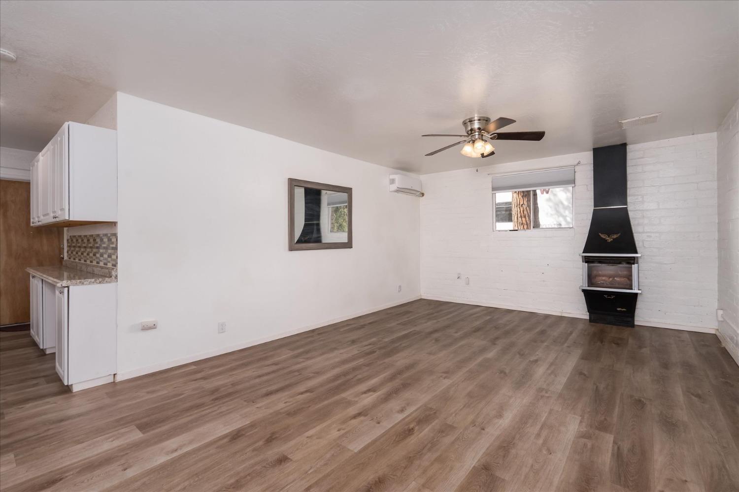 48994 Manzanita Road Oakhurst, CA 93644 - Photo 31 of 43 a view of empty room with wooden floor and fan