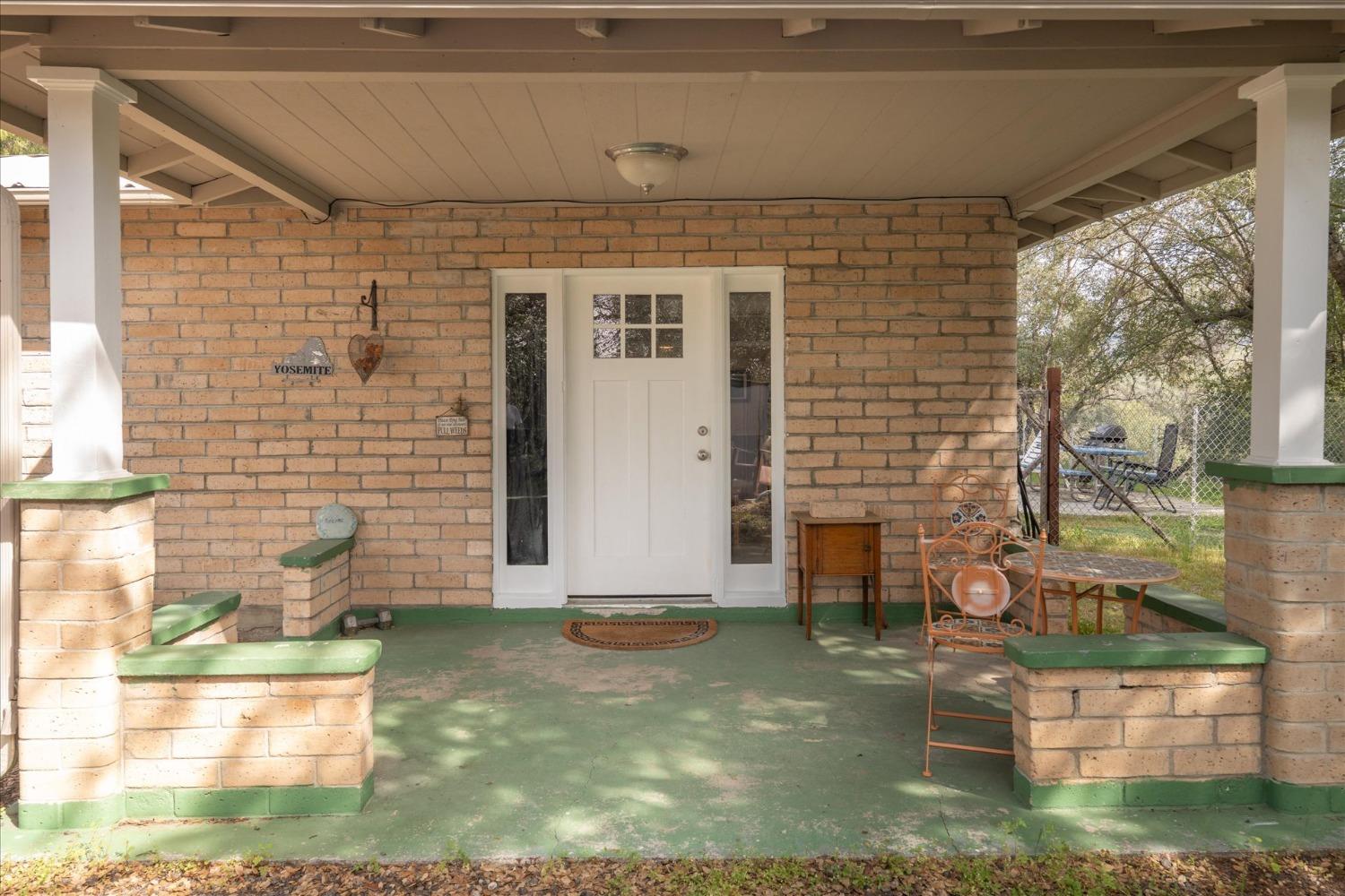 48994 Manzanita Road Oakhurst, CA 93644 - Photo 4 of 43 a front view of a house with a yard