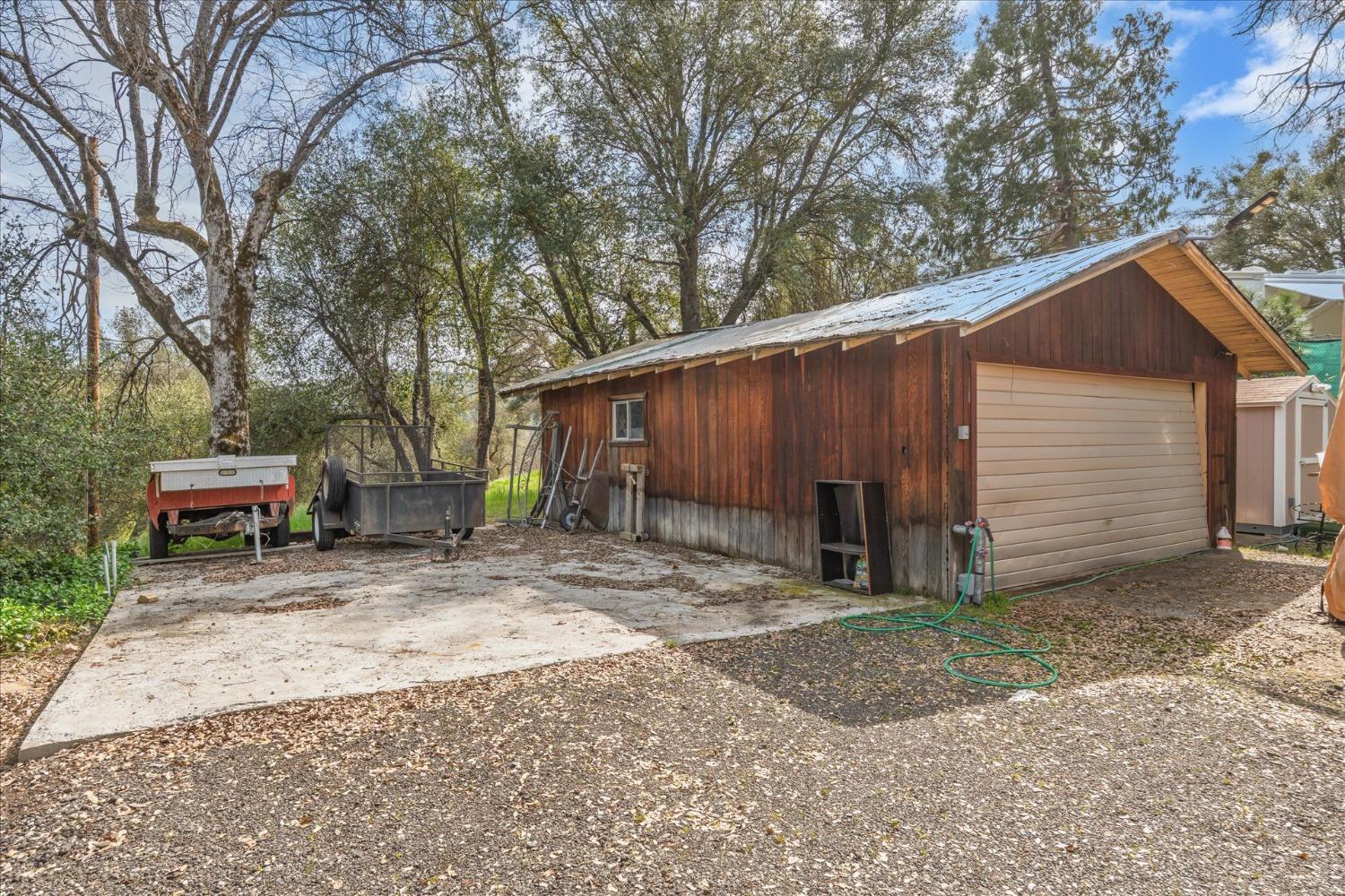 48994 Manzanita Road Oakhurst, CA 93644 - Photo 42 of 43 a view of a house with a yard and sitting area