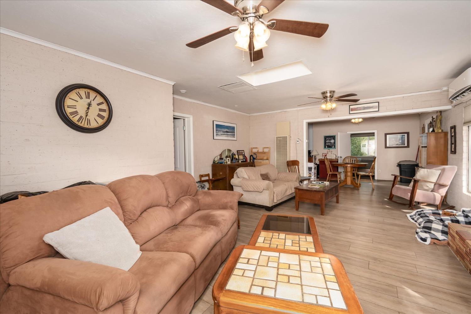 48994 Manzanita Road Oakhurst, CA 93644 - Photo 5 of 43 a living room with furniture a rug and a chandelier