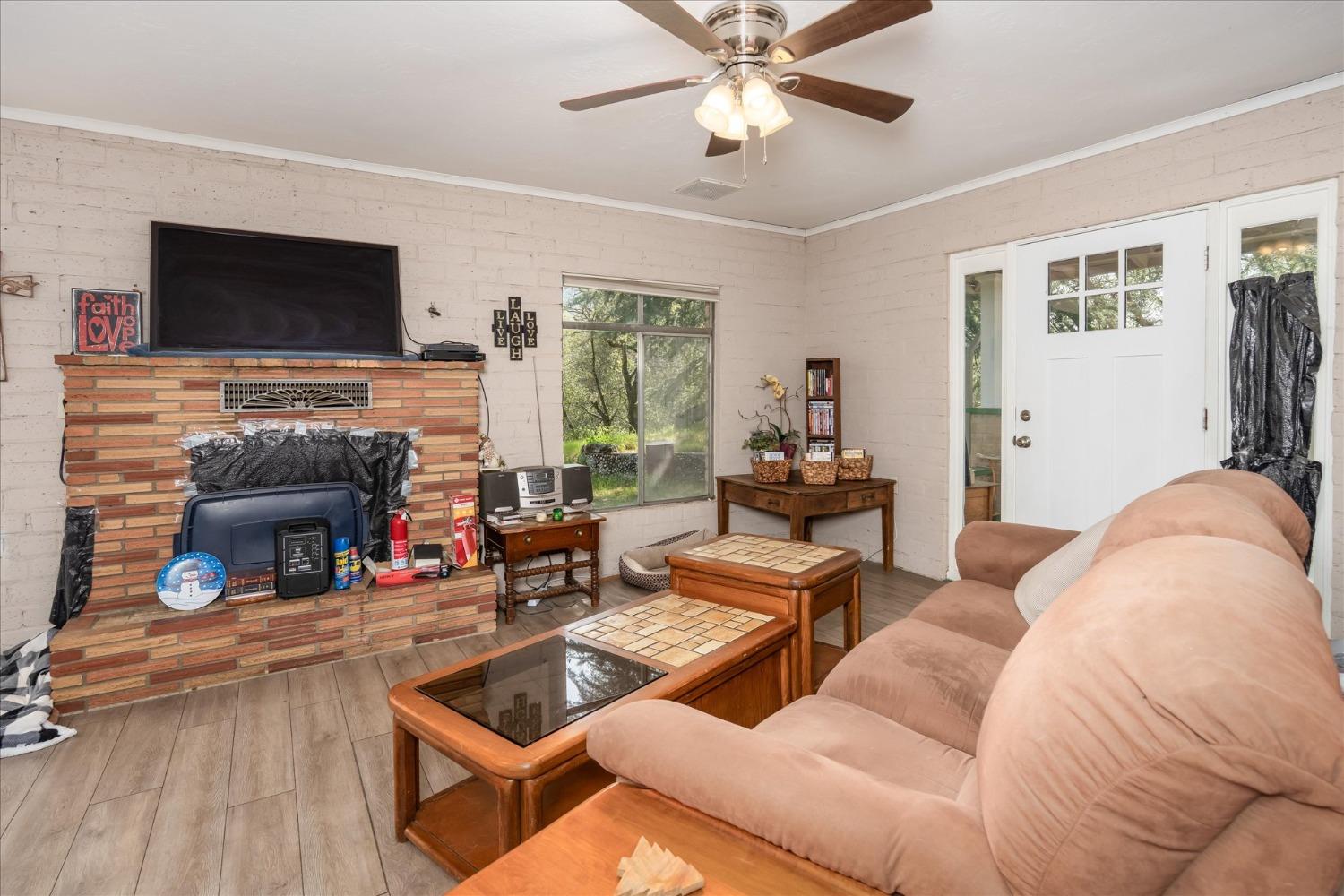 48994 Manzanita Road Oakhurst, CA 93644 - Photo 7 of 43 a living room with furniture and a flat screen tv