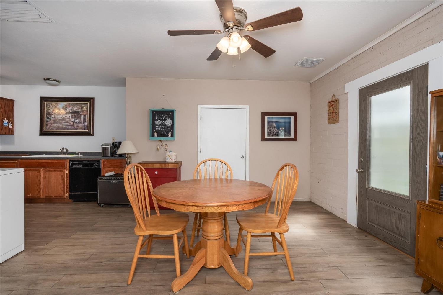 48994 Manzanita Road Oakhurst, CA 93644 - Photo 10 of 43 a view of a dining room with furniture and wooden floor