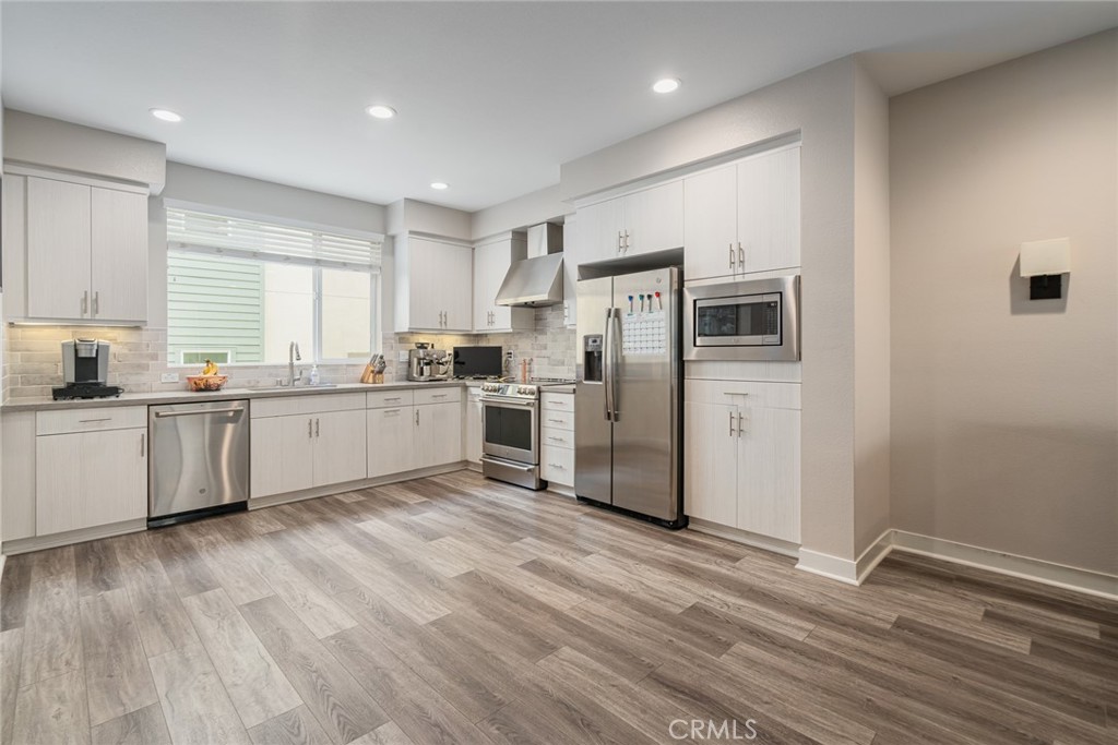 314 Bridgewater Way, Unit 4 Gardena, CA 90247 - Photo 1 of 1 a kitchen with refrigerator cabinets and wooden floor