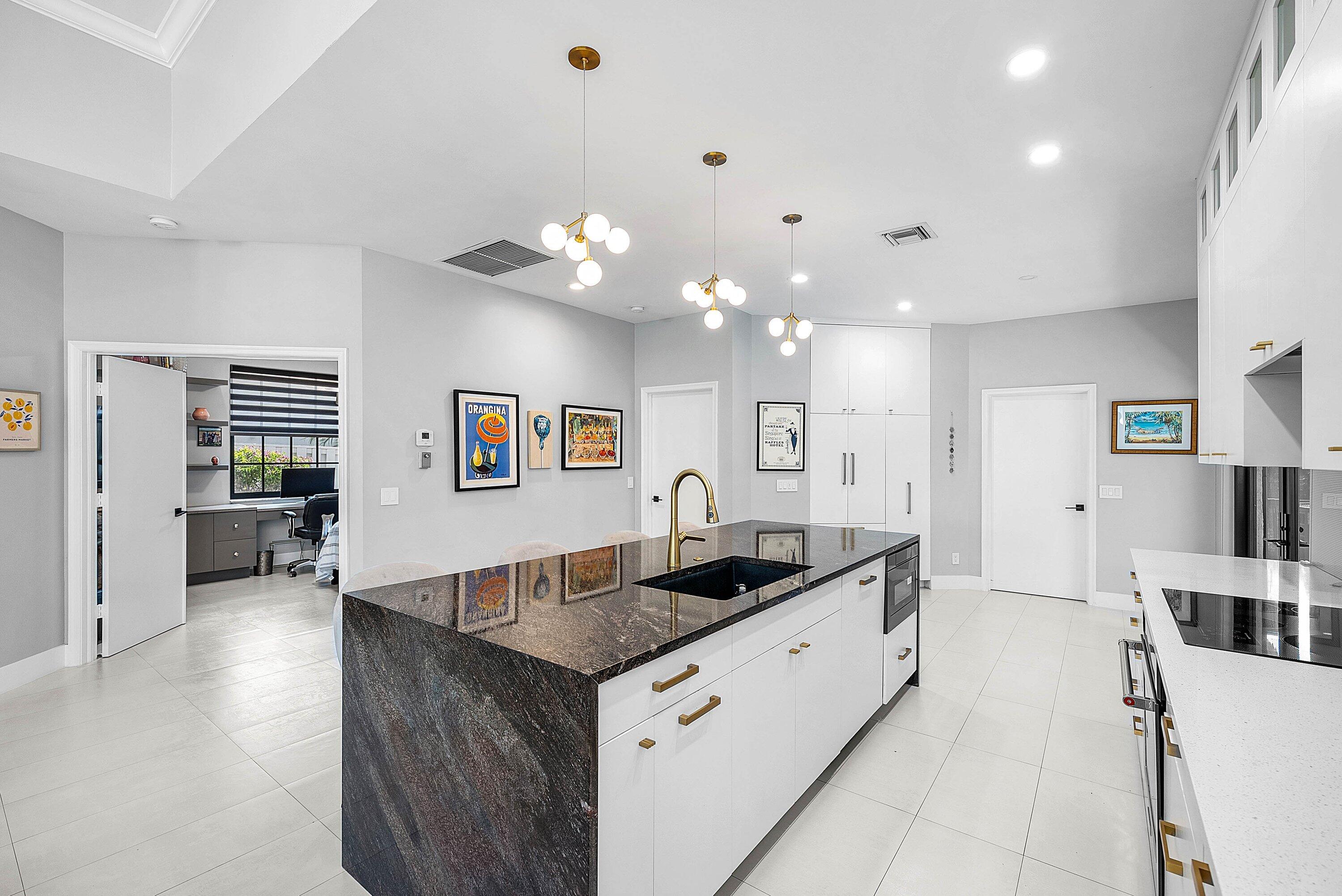 2413 Northwest 64th Street Boca Raton, FL 33496 - Photo 10 of 45 a kitchen with granite countertop a sink and cabinets