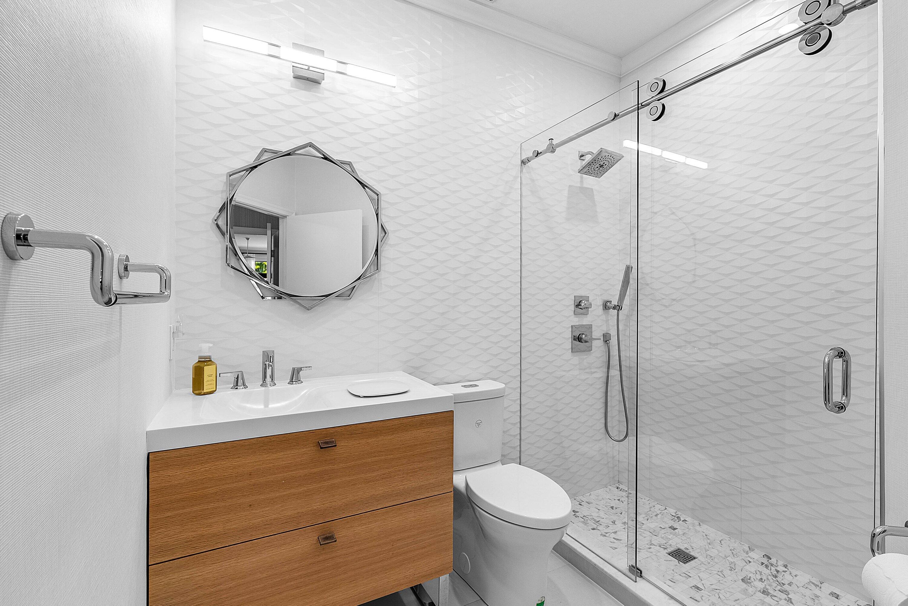 2413 Northwest 64th Street Boca Raton, FL 33496 - Photo 15 of 45 a bathroom with a sink a toilet and shower