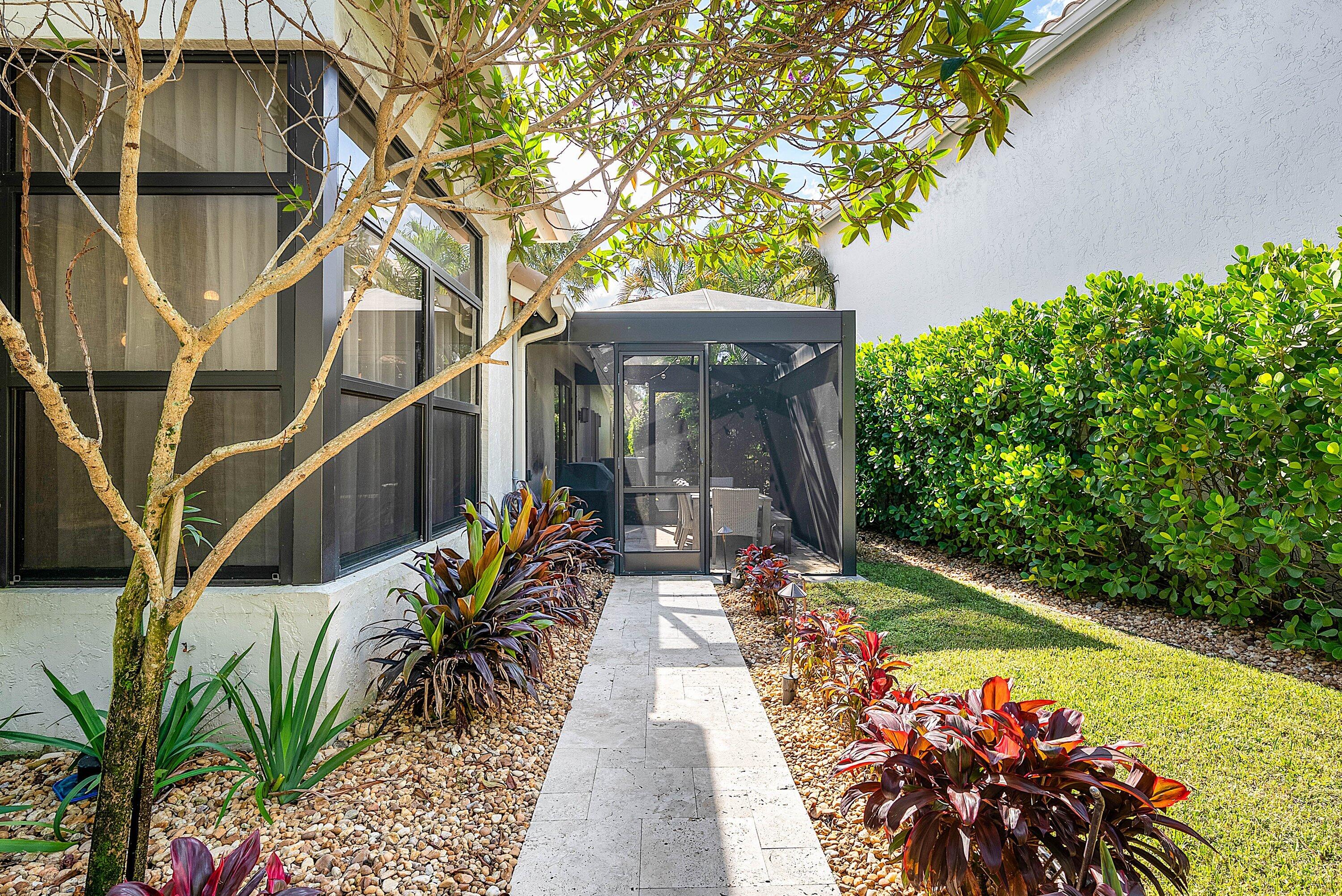 2413 Northwest 64th Street Boca Raton, FL 33496 - Photo 20 of 45 a view of a chairs and table in the backyard with potted plants