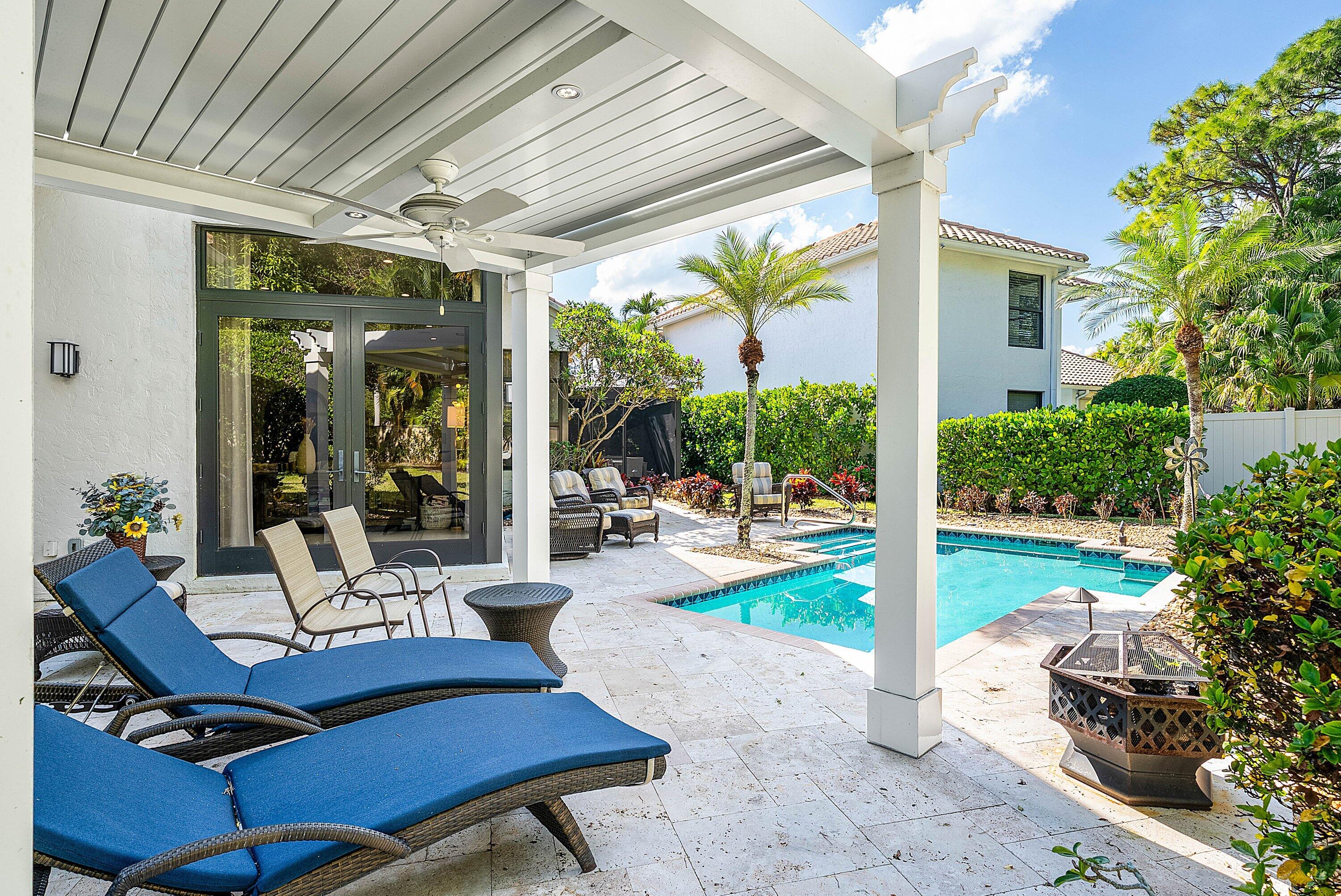 2413 Northwest 64th Street Boca Raton, FL 33496 - Photo 21 of 45 a building outdoor space with patio furniture and potted plants
