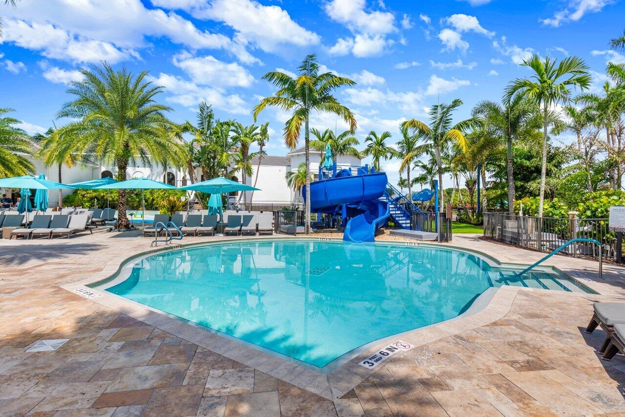 2413 Northwest 64th Street Boca Raton, FL 33496 - Photo 38 of 45 a swimming pool with outdoor seating and yard