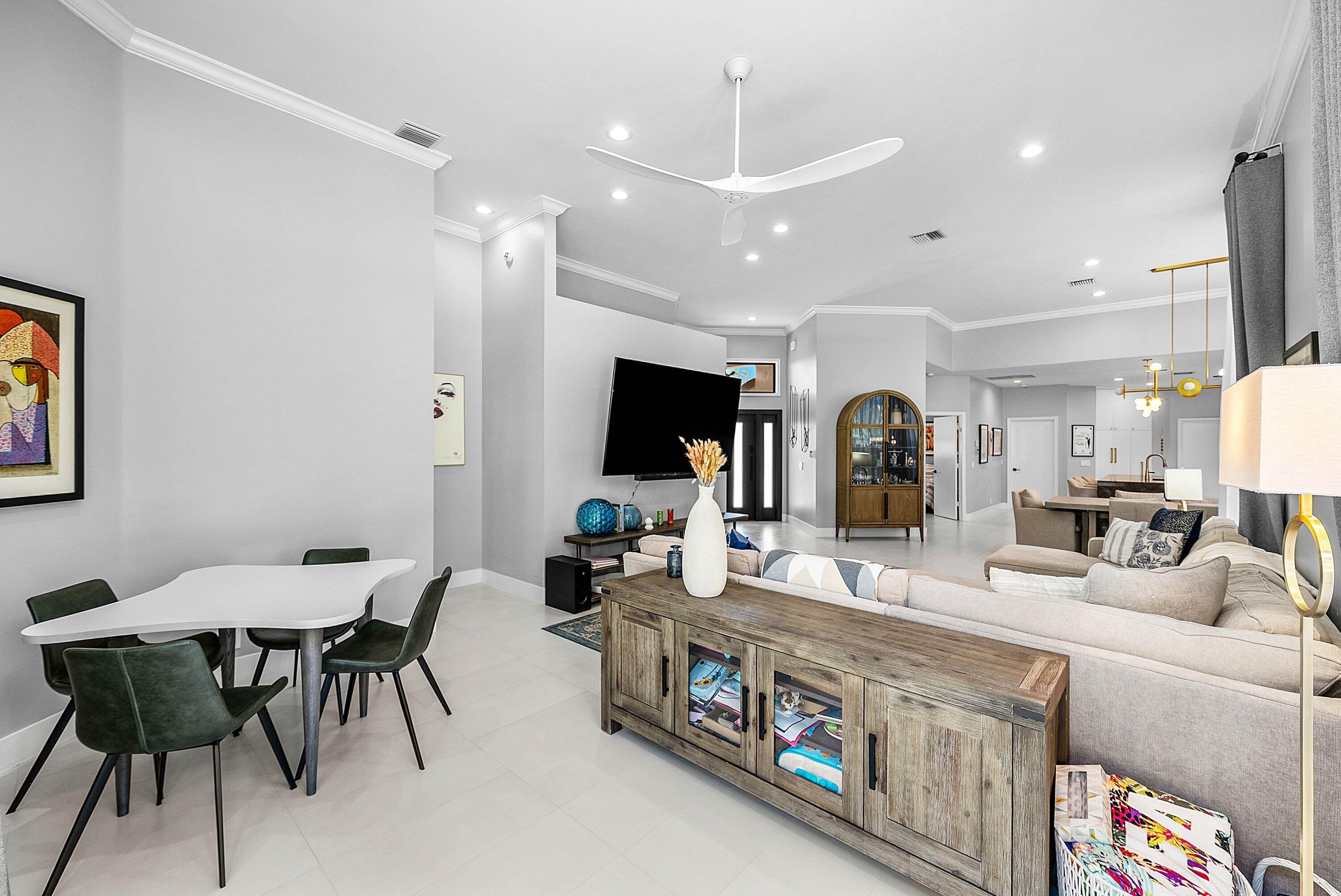 2413 Northwest 64th Street Boca Raton, FL 33496 - Photo 5 of 45 a large kitchen with a table and chairs