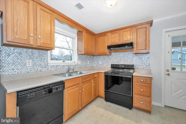 a kitchen with stainless steel appliances granite countertop a sink stove and cabinets