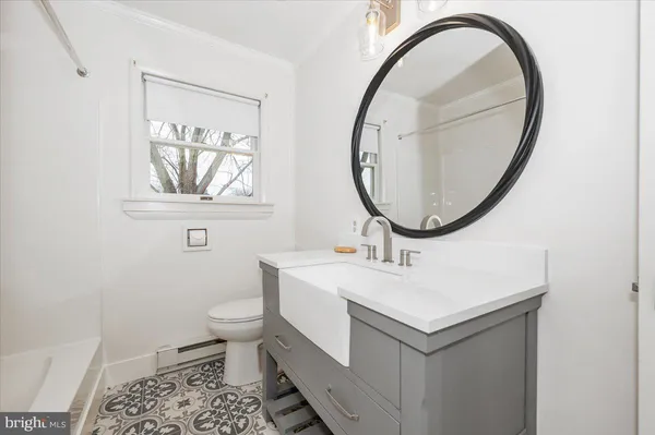 a bathroom with a sink a toilet and a mirror