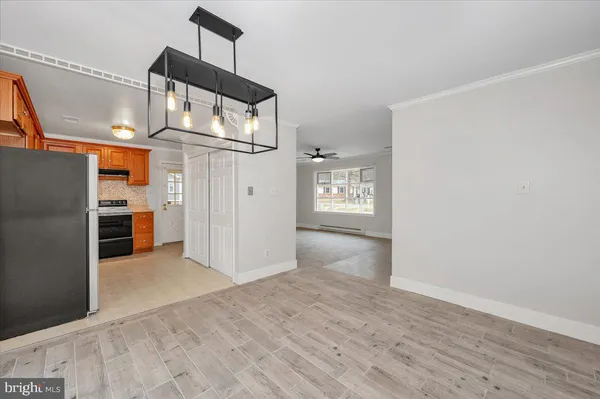 an empty room with wooden floor and cabinet