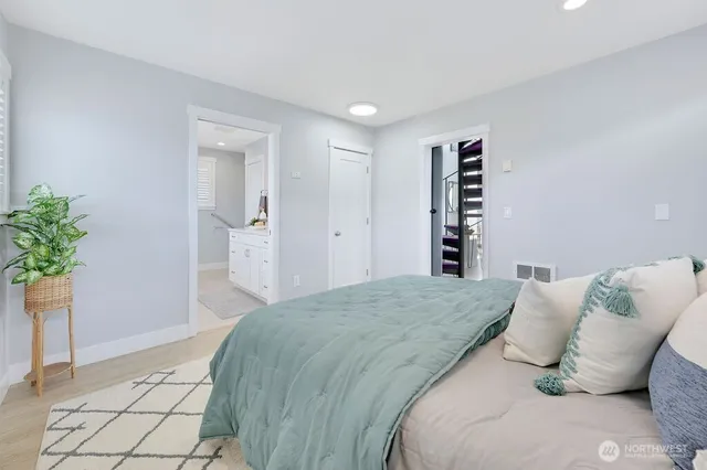 a bedroom with a bed and a potted plant